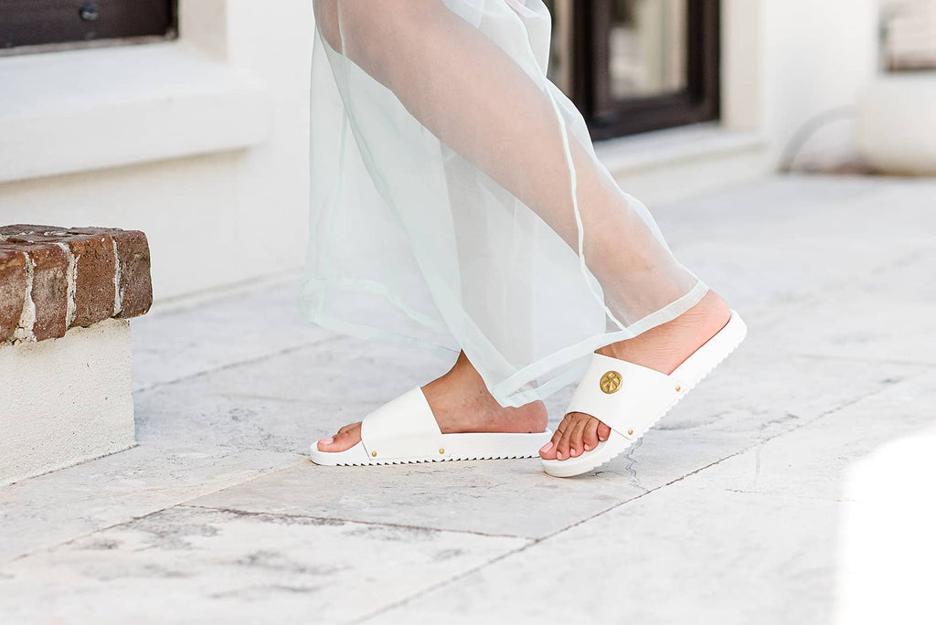 woman wearing luxury white slide sandals