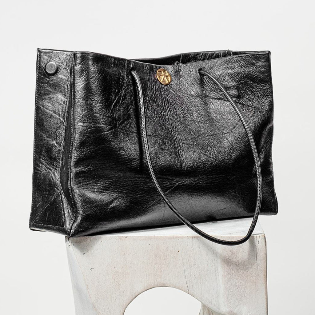 Gabi Handbag | Made with creased cowhide leather and adorned with our solid brass Kheloni coin.