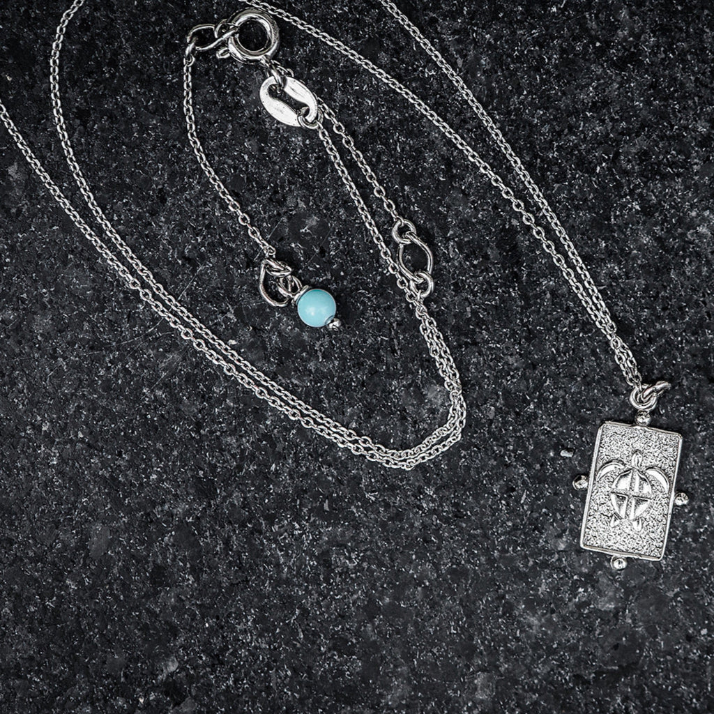 Sterling silver anklet with turtle charm and turquoise adornment. 