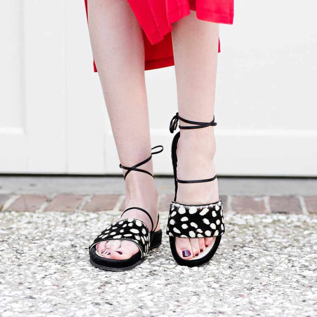 Woman wearing Rebekah | Sandal with rich black velvet and ivory spotted printed cowhide.