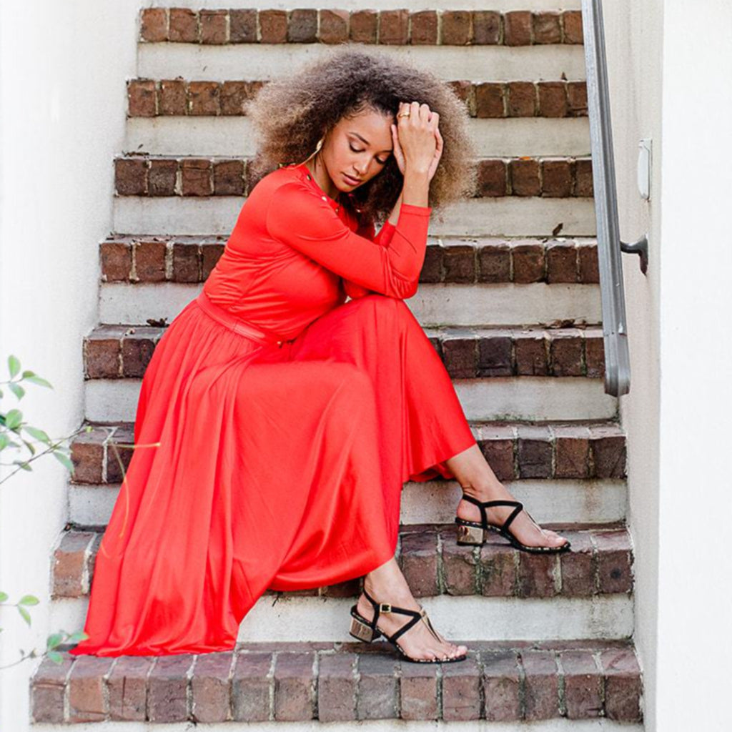woman wearing black Greek sandals with a platinum heel and a touch of gold