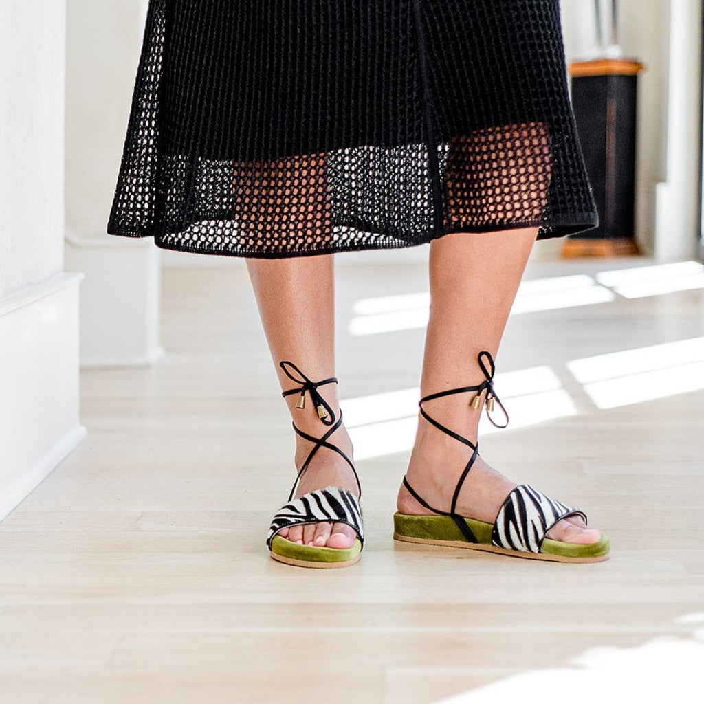 Woman wearing Nita - Handmade Greek Sandal with green velvet and zebra print.