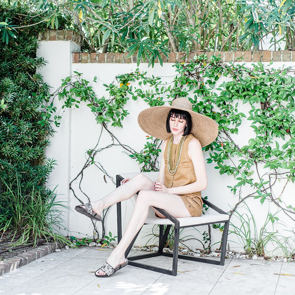 Womnan wearing Piperi | Handmade Greek sandal with chocolate colored velvet and pepper printed cowhide.