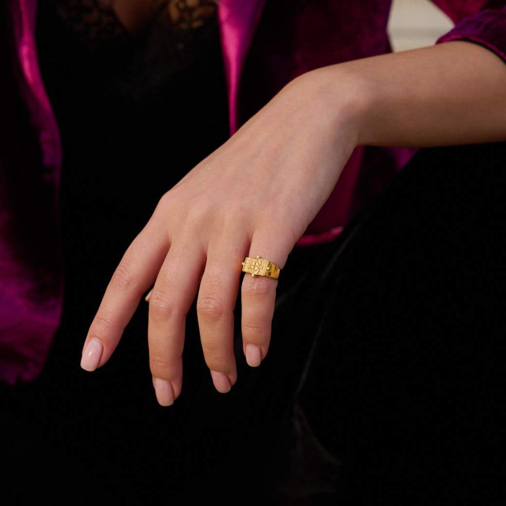 Model wearing ring that is plated 24K gold.