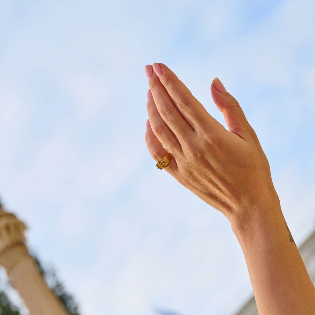 Model wearing ring that is plated 24K gold.